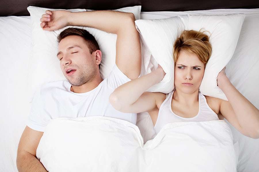 man snoring annoyed woman