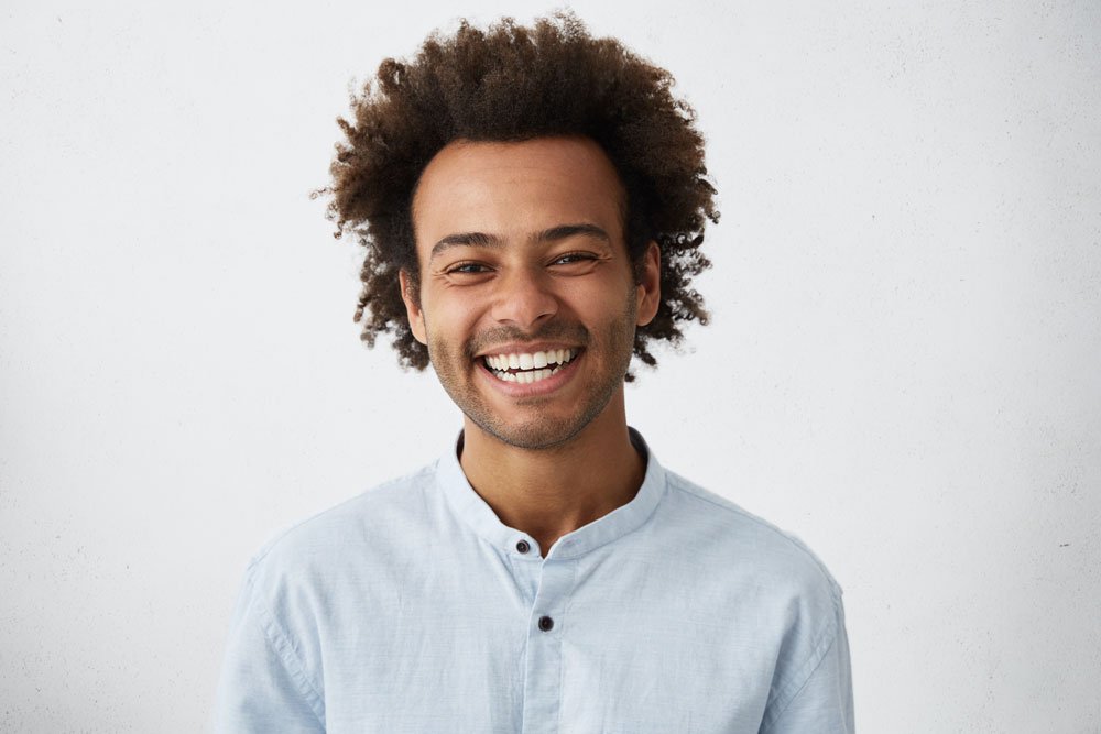 Smiling man showing off white teeth