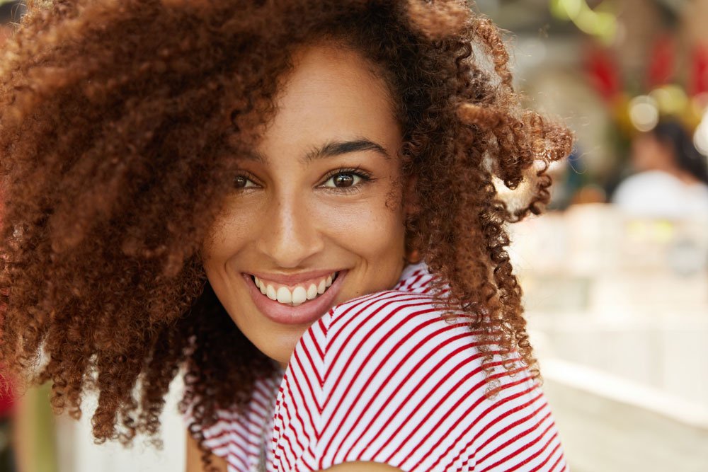 Young woman smiles happily