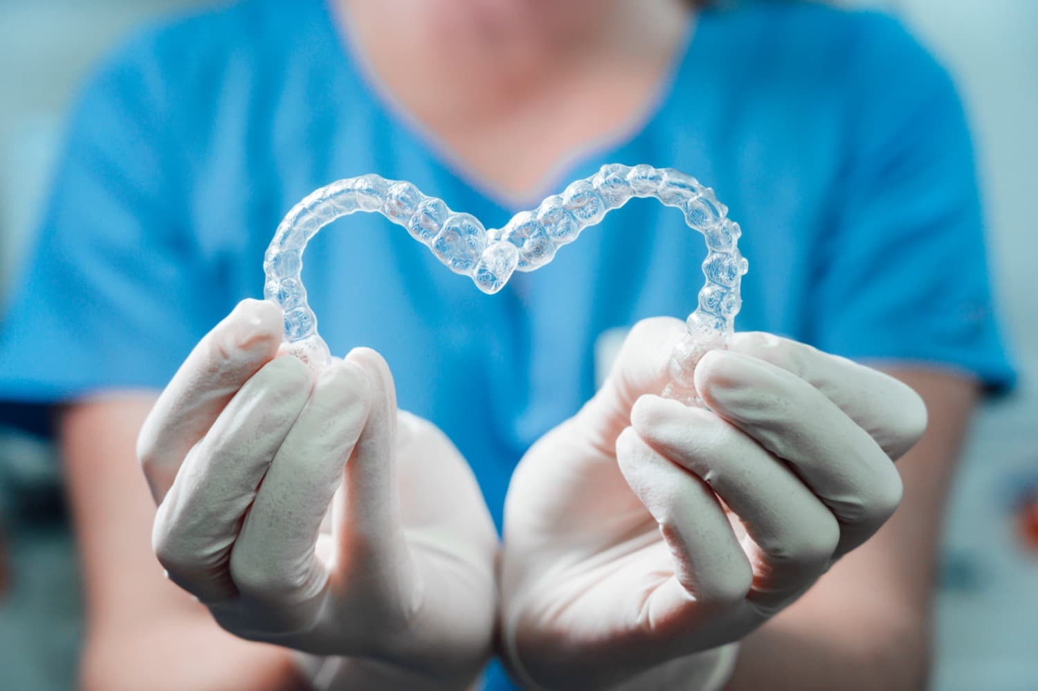 dentist making heart shape with retainers